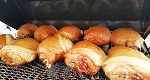 Grilling pork on the Carolina Pig Cooker.