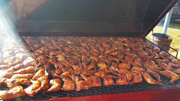 Grilling chicken on the Carolina Pig Cooker.